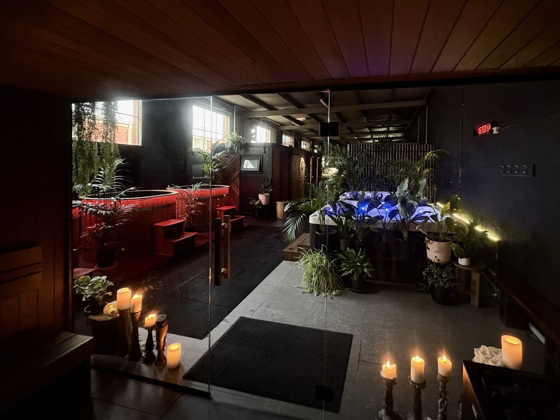 Candlelit interior of Vitality 4U with magnesium spas, plants and red-lit lounge